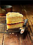 Sherry trifle cake slice with knife, vintage wooden table