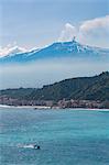 Small boat passing the awe inspiring Mount Etna, UNESCO World Heritage Site, and Europe's tallest active volcano, with Giardini Naxos, Sicily, Italy, Mediterranean, Europe
