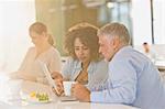 Business people drinking coffee and using digital tablet