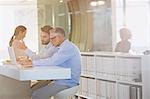 Businessmen working at laptop in office