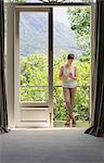 Woman texting with cell phone on luxury balcony