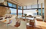 Modern luxury home showcase dining room and living room with sunny ocean view