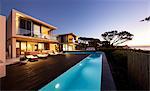 Modern luxury home showcase deck and swimming pool at sunset