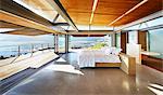 Modern luxury home showcase bed open to patio with sunny ocean view
