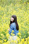 Attractive young Japanese woman in a rapeseed field