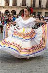 Cuba, Havana, Plaza de Armas, Habana Vieja.  A young girl participates in a public dancing display at Plaza de Armas, Havanas oldest square which was laid out in the 1520s.