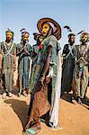 Niger, Agadez, Inebeizguine. Young Wodaabe men in traditional embroidered garments perform the rumi dance during a Gerewol ceremony.