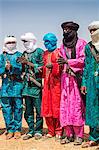 Niger, Agadez, Inebeizguine. Wodaabe men in colourful attire watch the young men of the tribe dance during a Gerewol ceremony.