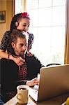 Hipster couple using laptop at home