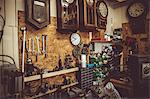 Old horologists workshop with clock repairing tools, equipments and clocks on the wall