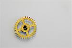 Clock gears on white paper in workshop