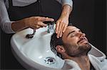 Man getting his hair wash at a salon