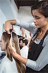 Female getting her hair trimmed at a salon