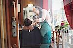 Man getting his beard shaved in a barber shop