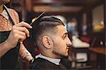 Man getting his hair trimmed in barber shop