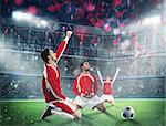 Soccer players exults on a stadium field