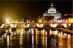 Night view on the Sant' Angelo Bridge and Basilica of St. Peter in Rome, Italy