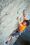 male rock climber. rock climber climbs on a rocky wall. focus on the hand