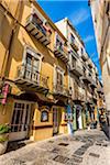 Shops along Narrow Street in Cefalu, Sicily, Italy