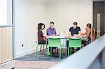 Design team meeting at design studio boardroom table