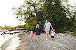 Mid adult parents strolling with boy and girl at Lake Ontario, Oshawa, Canada