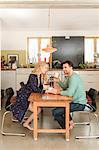 Couple at dining table drinking coffee