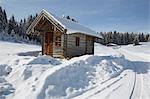 Log cabin on snow covered landscape, Elmau, Bavaria, Germany