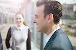 Businessman and woman on city footbridge, London, UK