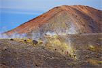 Europe, Italy, Sicily, Aeolian Islands, Vulcano Island,, People walking through fumaroles smoke on Volcano Gran cratere,