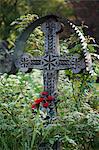 Romania, Maramures, Breb. A carved wooden cross marking a grave in the cemetery.