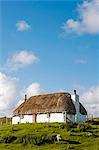 UK, Scotland, Outer Hebrides, North Uist.  A traditional thatched whitehouse on the south east coast of North Uist.