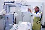 Doctor using x-ray machine to examine patient in hospital