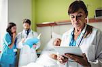 Female doctor using digital tablet in hospital