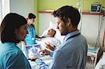 Male doctor and nurse looking at digital tablet in hospital