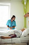 Nurse consoling senior patient in hospital