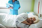 Senior patient sleeping on a bed in hospital