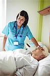 Nurse checking senior patient in hospital