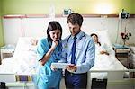 Doctor and nurse using digital tablet in hospital