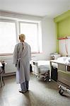 Senior woman standing in hospital ward