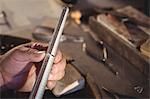 Close-up of goldsmith measuring ring in workshop