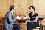 Man and woman sitting in cafe drinking coffee