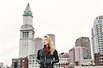 Woman with hands in pockets looking away, Boston, Massachusetts, USA