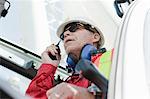 Engineer using walkie talkie on oil rig