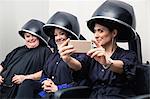 Customers taking selfie under hair dryers