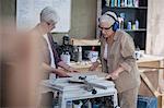 Female carpenters preparing wood in furniture making workshop