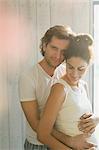 Portrait affectionate pregnant couple hugging