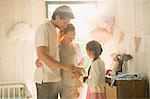 Pregnant family with stuffed animal in nursery