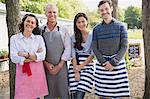 Portrait smiling cafe small business owners wearing aprons