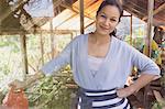 Portrait smiling woman gardening in greenhouse