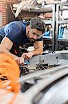 Focused mechanic fixing car in auto repair shop